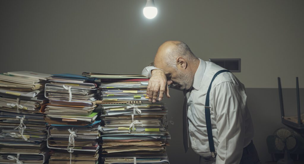 Desperate business executive with lots of paperwork
